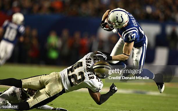 Austin Collie of the Indianapolis Colts is hit by Darren Sharper of the New Orleans Saints during Super Bowl XLIV on February 7, 2010 at Sun Life...