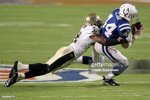Dallas Clark of the Indianapolis Colts runs with the ball after making a catch against Roman Harper of the New Orleans Saints during Super Bowl XLIV...