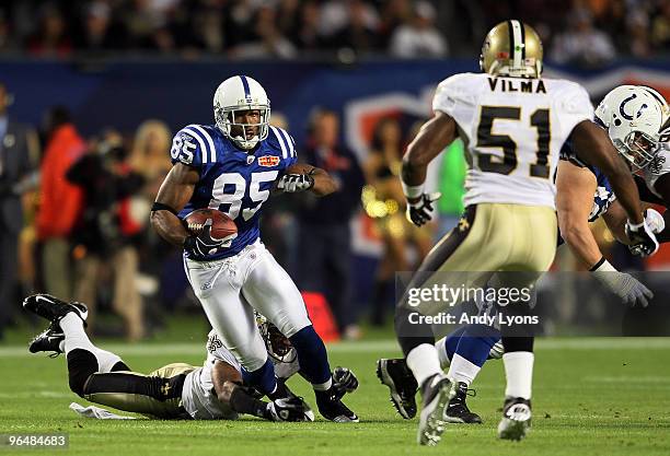 Pierre Garcon of the Indianapolis Colts runs with the ball after a catch against Jonathan Vilma of the New Orleans Saints during Super Bowl XLIV on...