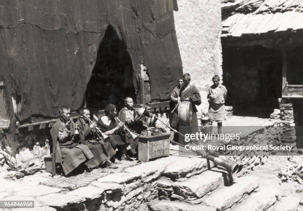 Thyangboche Monastery with monks playing musical instruments, Nepal, March 1953. Mount Everest Expedition 1953.