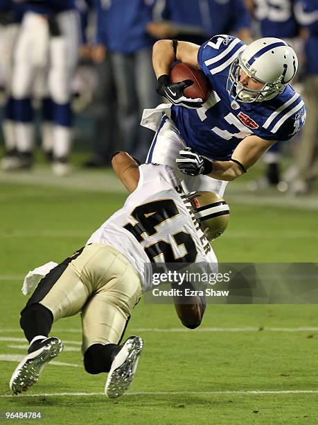 Austin Collie of the Indianapolis Colts is tacked after making a catch by Darren Sharper of the New Orleans Saints during Super Bowl XLIV on February...