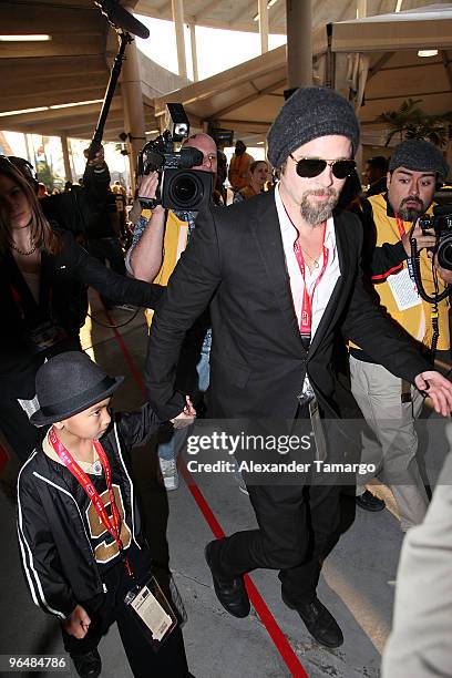 Actor Brad Pitt and Maddox Jolie-Pitt attend Super Bowl XLIV at the Sun Life Stadium on February 7, 2010 in Miami Gardens, Florida.