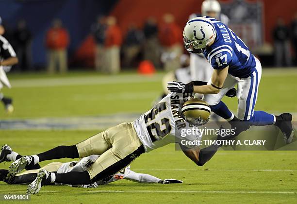 The Indianapolis Colts' Austin Collie is hit by the New Orleans Saints' Darren Sharper durinf first down in the first quarter of the Super Bowl XLIV...