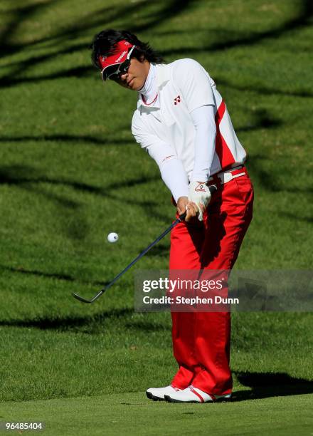 Ryo Ishikawa of Japan chips onto the green on the fourth hole during the final round of the Northern Trust Open at Riviera Country Club on February...