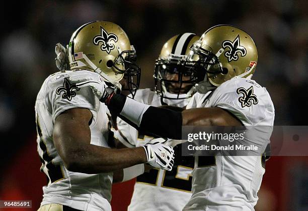 Jonathan Vilma, Tracy Porter and Roman Harper of the New Orleans Saints celebrate after a play against the Indianapolis Colts during Super Bowl XLIV...