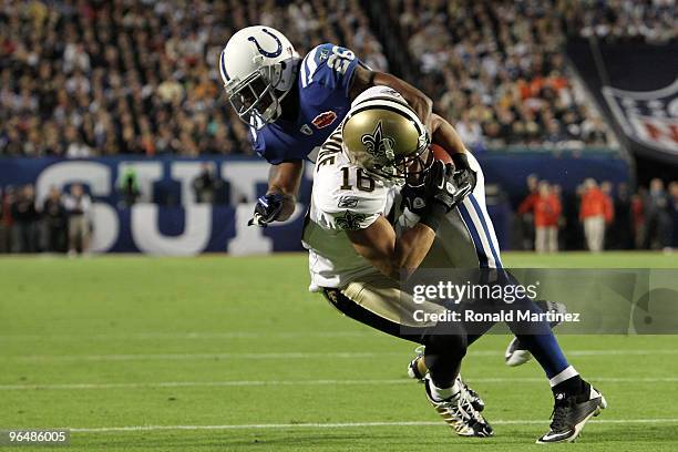 Lance Moore of the New Orleans Saints is hit by Kelvin Hayden of the Indianapolis Colts during Super Bowl XLIV on February 7, 2010 at Sun Life...