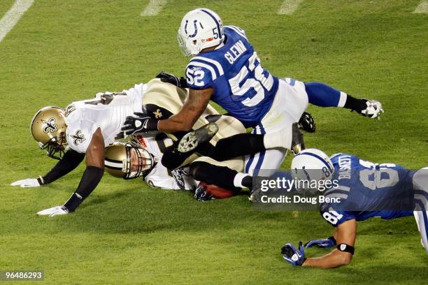 Chris Reis and Roman Harper of the New Orleans Saints fight for the ball with Cody Glenn and Hank Baskett of the Indianapolis Colts after a onside...