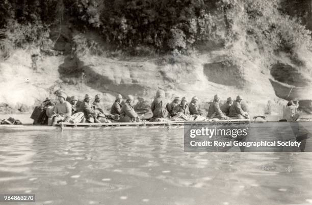 Riflemen in dug-out canoe - Assam, India, 1935.