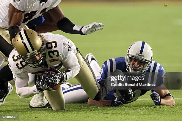 Chris Reis of the New Orleans Saints fight for the ball against Hank Baskett of the Indianapolis Colts after a onside kick to start the second half...