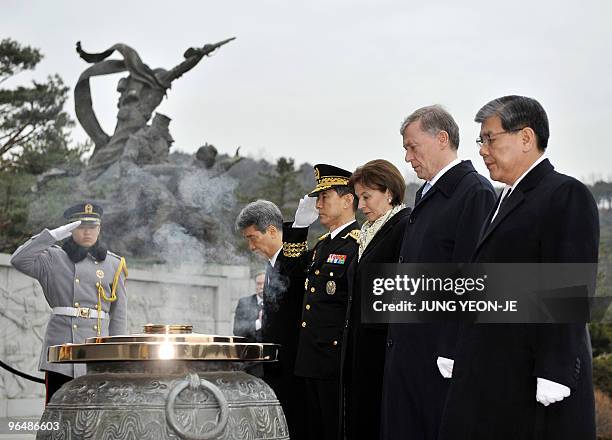 German President Horst Kohler and his wife Eva Luise Kohler pay their respects at the National Cemetery in Seoul on February 8, 2010. South Korean...