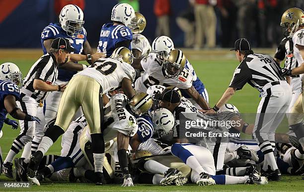 The New Orleans Saints and Indianapolis Colts fight for a loose ball after a onside kick to start the second half with during Super Bowl XLIV on...