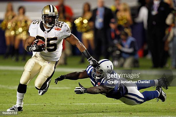 Reggie Bush of the New Orleans Saints runs with the ball against Clint Session of the Indianapolis Colts during Super Bowl XLIV on February 7, 2010...