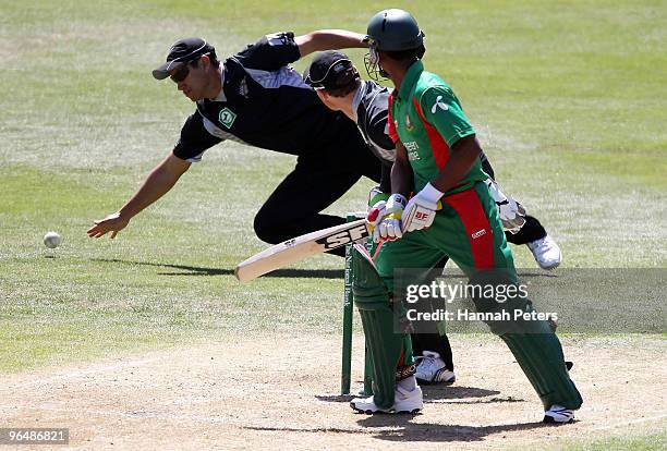 Naeem Islam of Bangladesh flicks the ball past Ross Taylor of New Zealand during the second One Day International Match between New Zealand and...