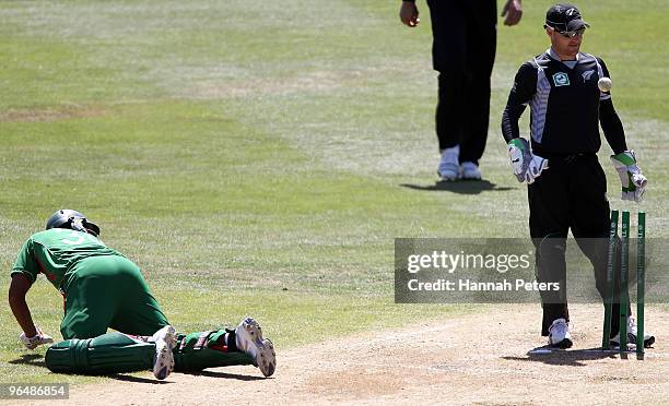 Mohammad Mahmudullah of Bangladesh is run out as Brendon McCullum of New Zealand waits for a decision from the umpire during the second One Day...