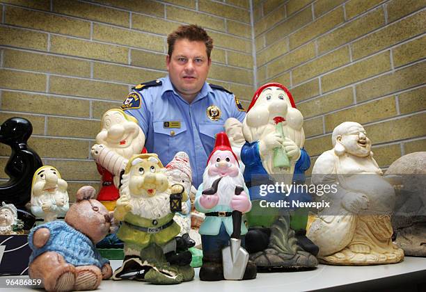 Sergeant Jason Hutcheon poses with a collection of garden gnomes at Bridgewater Police Station on February 01, 2010 in Hobart, Australia. The...