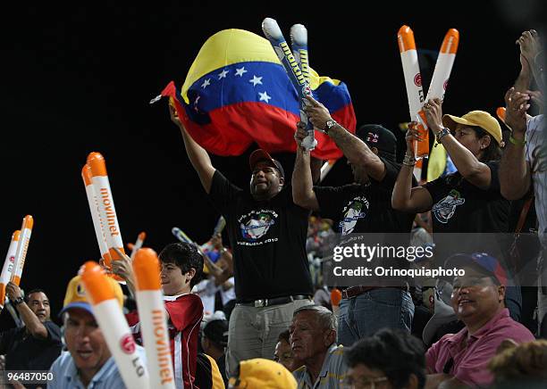 Supporters of Leones del Caracas cheer their team during a game against Indios de Mayaguez as part of the Caribbean Baseball Series 2010 at the...