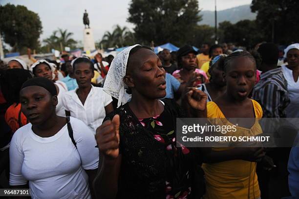 To go with scene story Haiti-quake-religion A Haitian women pray during a mass at an intersection near the presidential palace in Port-au-Prince on...