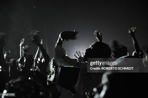 To go with scene story Haiti-quake-religion Haitians raise their arms in prayer during a mass at an intersection near the presidential palace in...