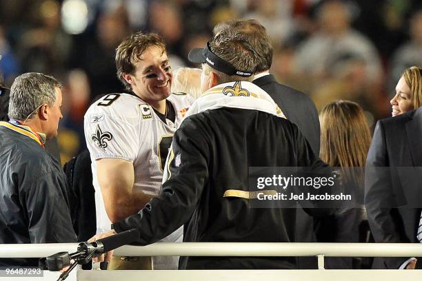 Drew Brees and head coach Sean Payton of the New Orleans Saints react after defeating the Indianapolis Colts during Super Bowl XLIV on February 7,...