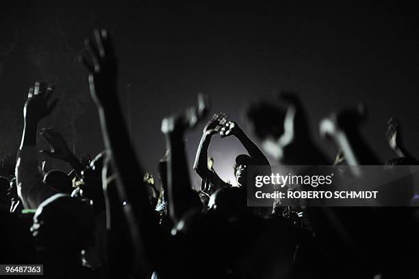 To go with scene story Haiti-quake-religion Haitians raise their arms in prayer during a mass at an intersection near the presidential palace in...