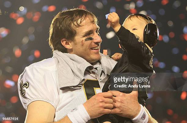 Drew Brees of the New Orleans Saints celebrates with his son Baylen Brees after defeating the Indianapolis Colts during Super Bowl XLIV on February...
