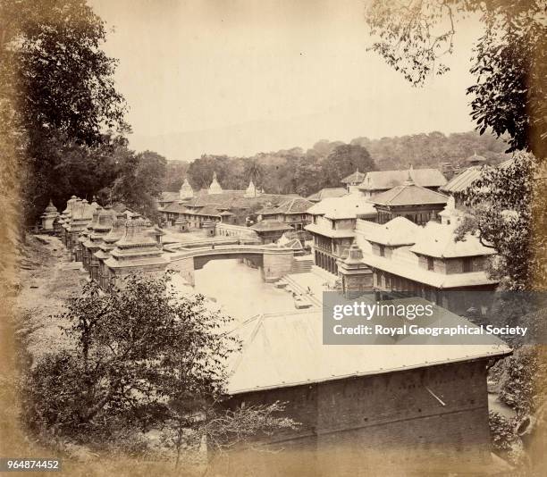 Bridge over the Baghmati River at Pashupatinath in the Kathmandu Valley, Long flights of stone steps known as the 'Ghats' on the riverbanks of the...