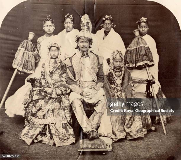 Jung Bahadur with two of his daughters and slave girls standing behind them, Nepal, 1863.