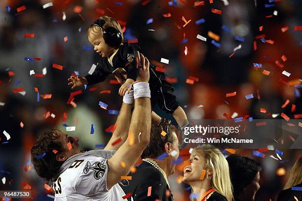 Drew Brees of the New Orleans Saints celebrates with his son Baylen Brees as his wife Brittany Brees looks on after defeating the Indianapolis Colts...