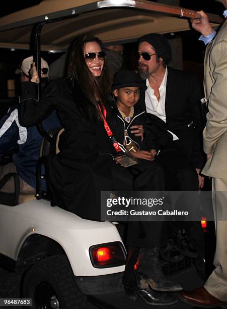 Angelina Jolie, Maddox Jolie-Pitt and Brad Pitt are seen leaving Super Bowl XLIV at Sun Life Stadium on February 7, 2010 in Miami Gardens, Florida.