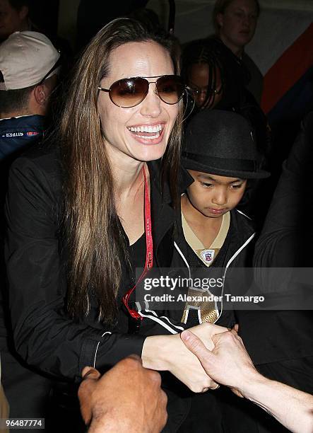 Actress Angelina Jolie and Maddox Jolie-Pitt leave Super Bowl XLIV at the Sun Life Stadium on February 7, 2010 in Miami Gardens, Florida.