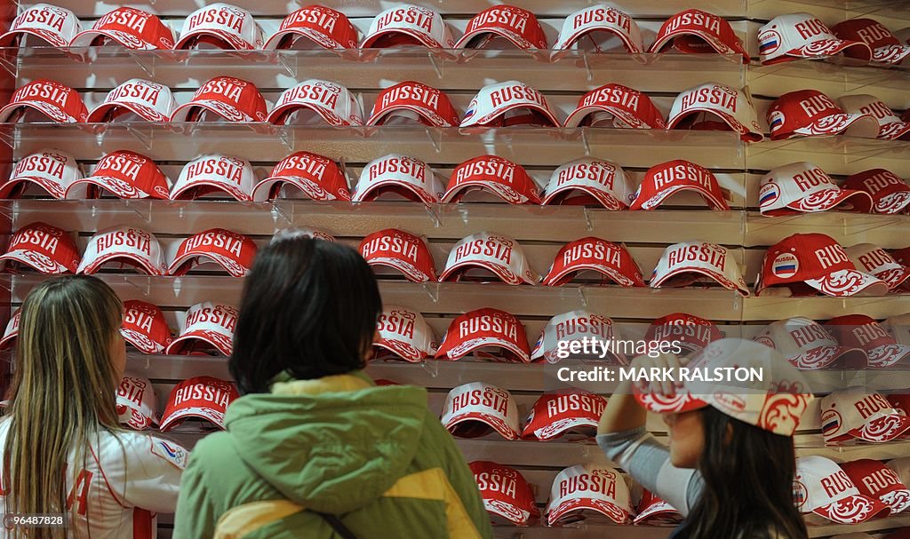 A family looks at caps for sale in the R
