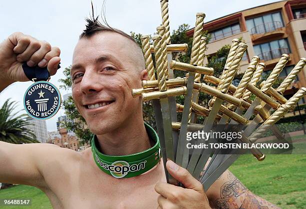Internationally renowned street performer Chayne Hultgren , displays the 18 swords he swallowed for a Guinness World Record attempt in Sydney on...