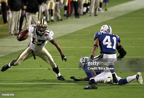 Robert Meachem of the New Orleans Saints runs with the ball against Antoine Bethea of the Indianapolis Colts during Super Bowl XLIV on February 7,...