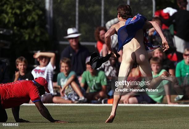 Streaker makes his way onto the ground during the second One Day International Match between New Zealand and Bangladesh at University Oval on...