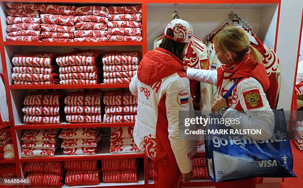 Russian athletes look at a display of Russian Winter Olympic team merchandise at the Hudson's Bay department store in downtown Vancouver on February...