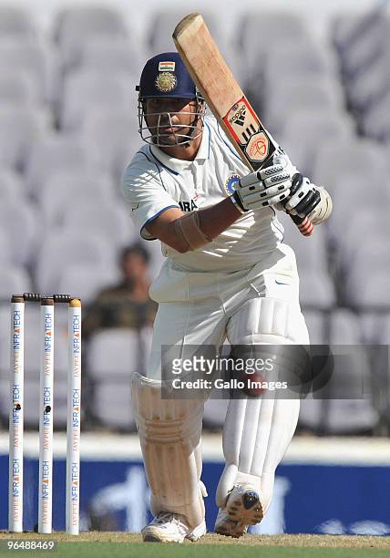 Sachin Tendulkar of India drives straight for a boundary during day three of the First Test between India and South Africa at Vidarbha Cricket...