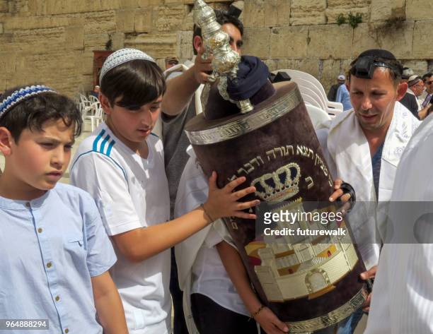 bar mitzvah procession carrying the torah in front of the wailing wall in jerusalem, israel, march 8, 2018 - torah imagens e fotografias de stock