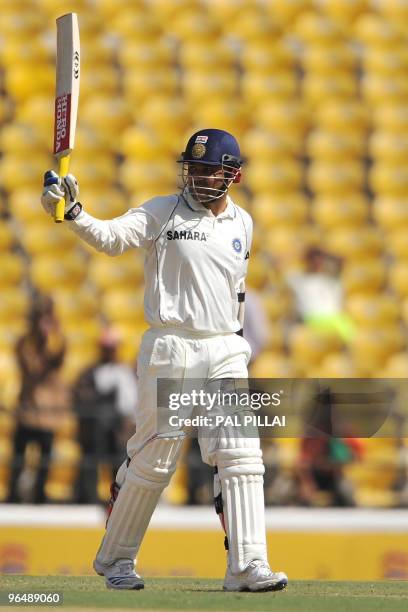 Indian cricketer Virender Sehwag raises his bat after hitting a half century on the third day of the first cricket Test match between India and South...