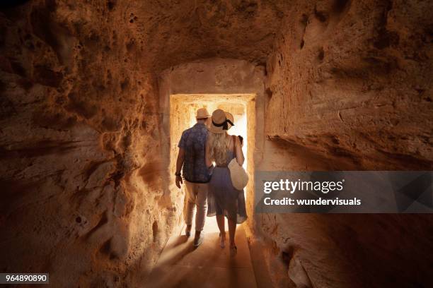 tourists walking in dark passage at archaeological site in greece - ancient ruins stock pictures, royalty-free photos & images