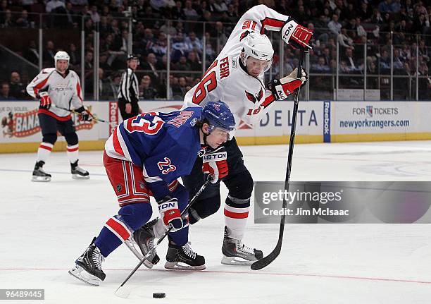 Eric Fehr of the Washington Capitals steals the puck from Chris Drury of the New York Rangers on February 4, 2010 at Madison Square Garden in New...