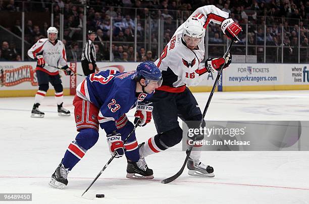 Eric Fehr of the Washington Capitals steals the puck from Chris Drury of the New York Rangers on February 4, 2010 at Madison Square Garden in New...