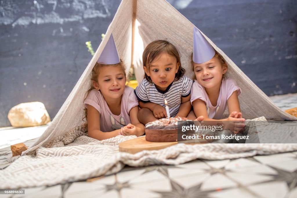 Birthday twin girls and a toddler boy in a tent