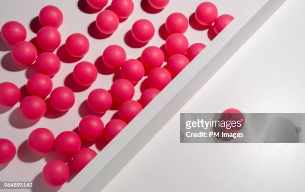 one red ball separated from many others - exclusive foto e immagini stock