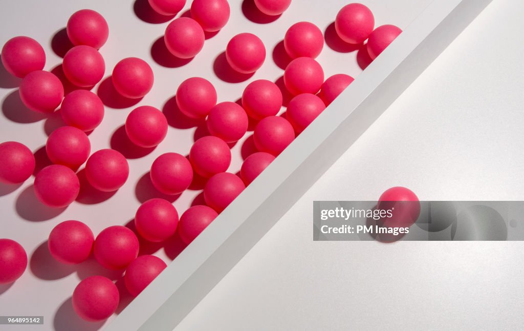 One red ball separated from many others