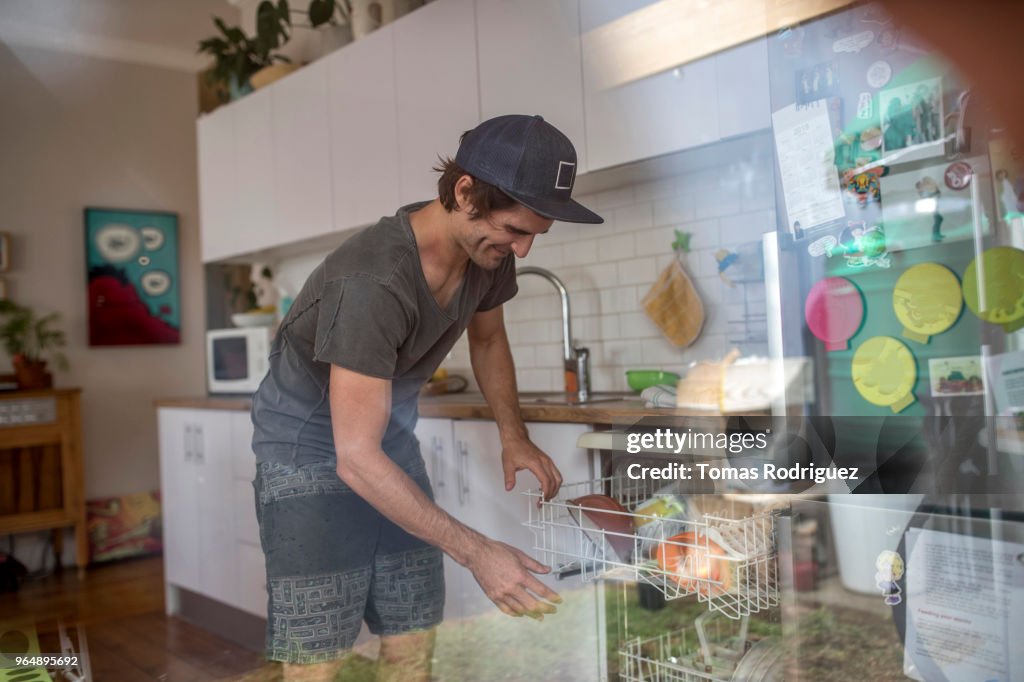 Man emptying the dishwasher