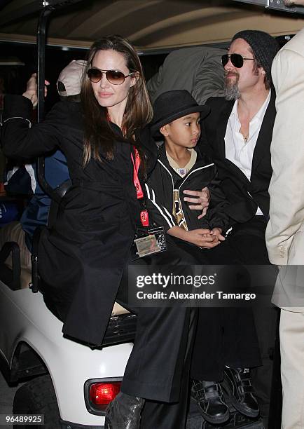 Angelina Jolie, Maddox Jolie-Pitt and Brad Pitt are seen leaving Super Bowl XLIV at Sun Life Stadium on February 7, 2010 in Miami Gardens, Florida.