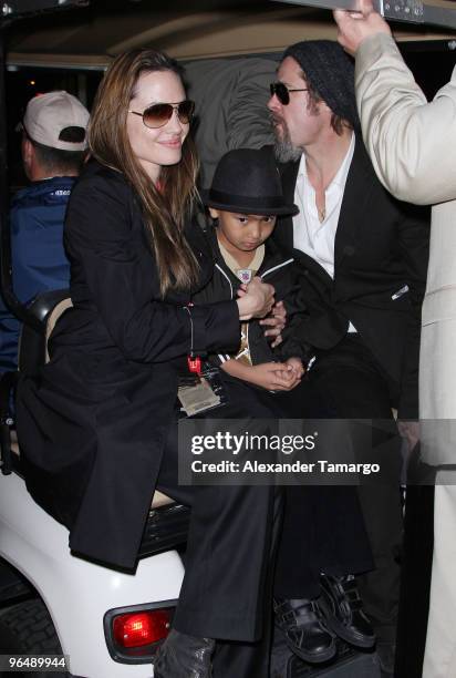 Angelina Jolie, Maddox Jolie-Pitt and Brad Pitt are seen leaving Super Bowl XLIV at Sun Life Stadium on February 7, 2010 in Miami Gardens, Florida.