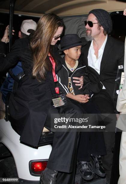 Angelina Jolie, Maddox Jolie-Pitt and Brad Pitt are seen leaving Super Bowl XLIV at Sun Life Stadium on February 7, 2010 in Miami Gardens, Florida.