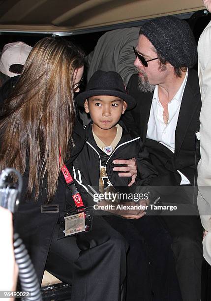 Angelina Jolie, Maddox Jolie-Pitt and Brad Pitt are seen leaving Super Bowl XLIV at Sun Life Stadium on February 7, 2010 in Miami Gardens, Florida.