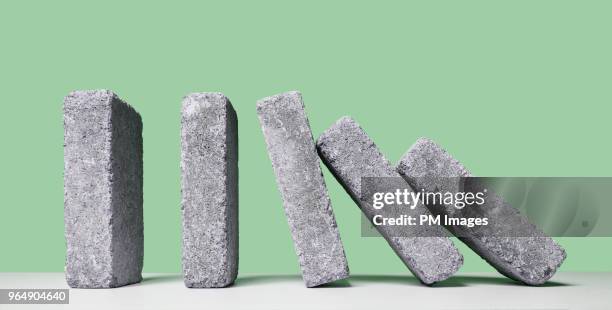 concrete blocks falling like dominos - concrete block stock pictures, royalty-free photos & images